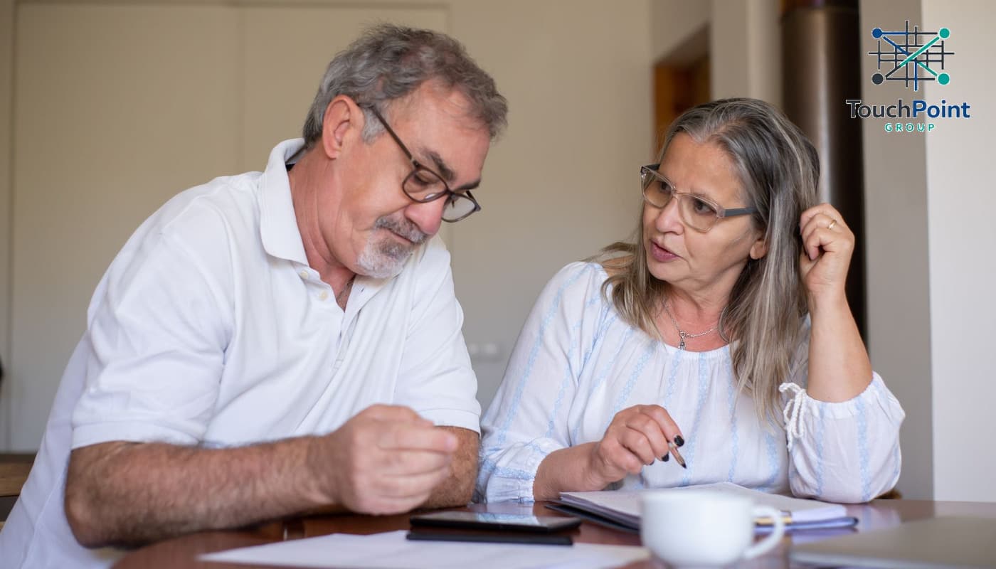 Illustrative household discussing financial paperwork at home
